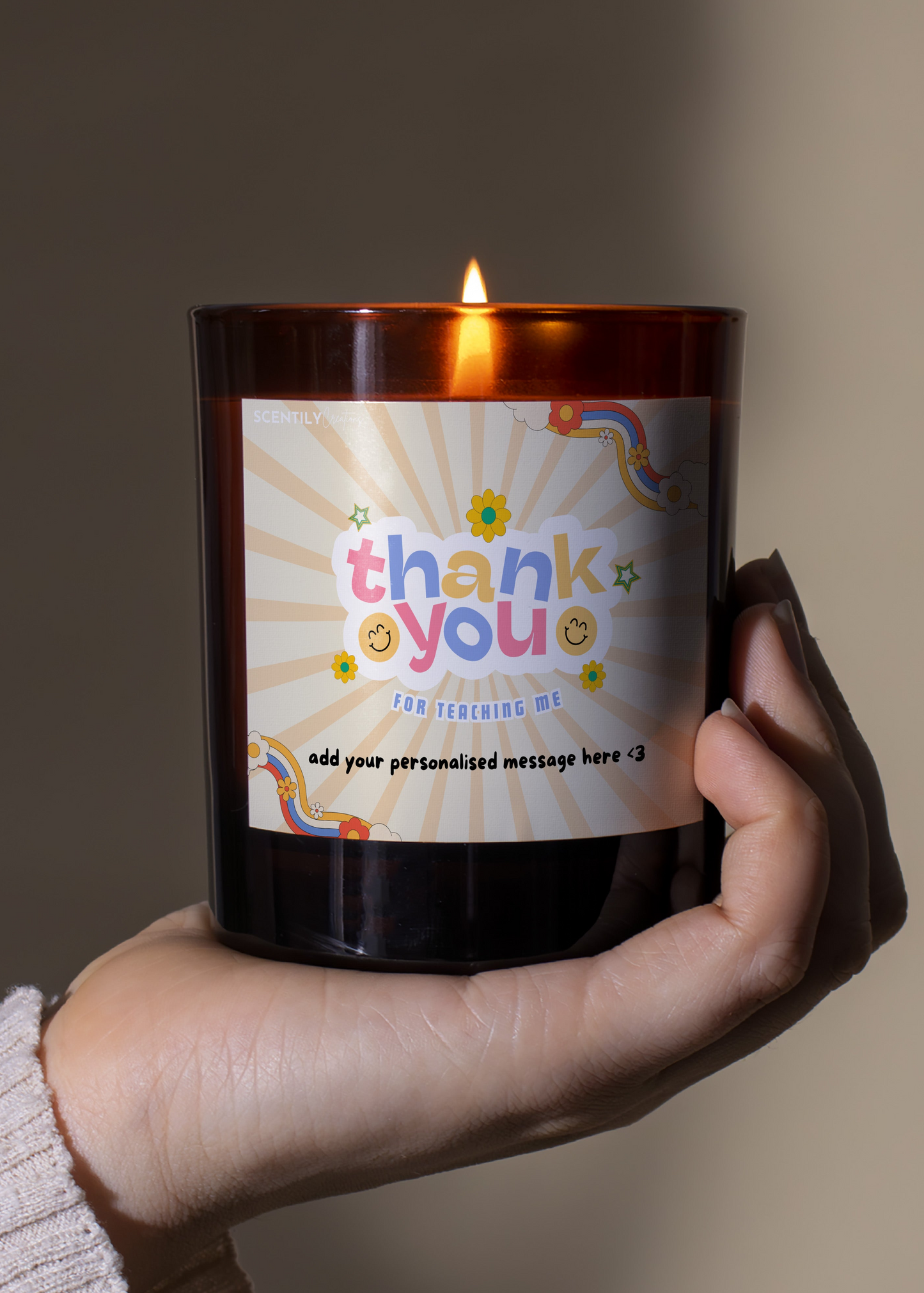 a person holding a thank you candle in their hand